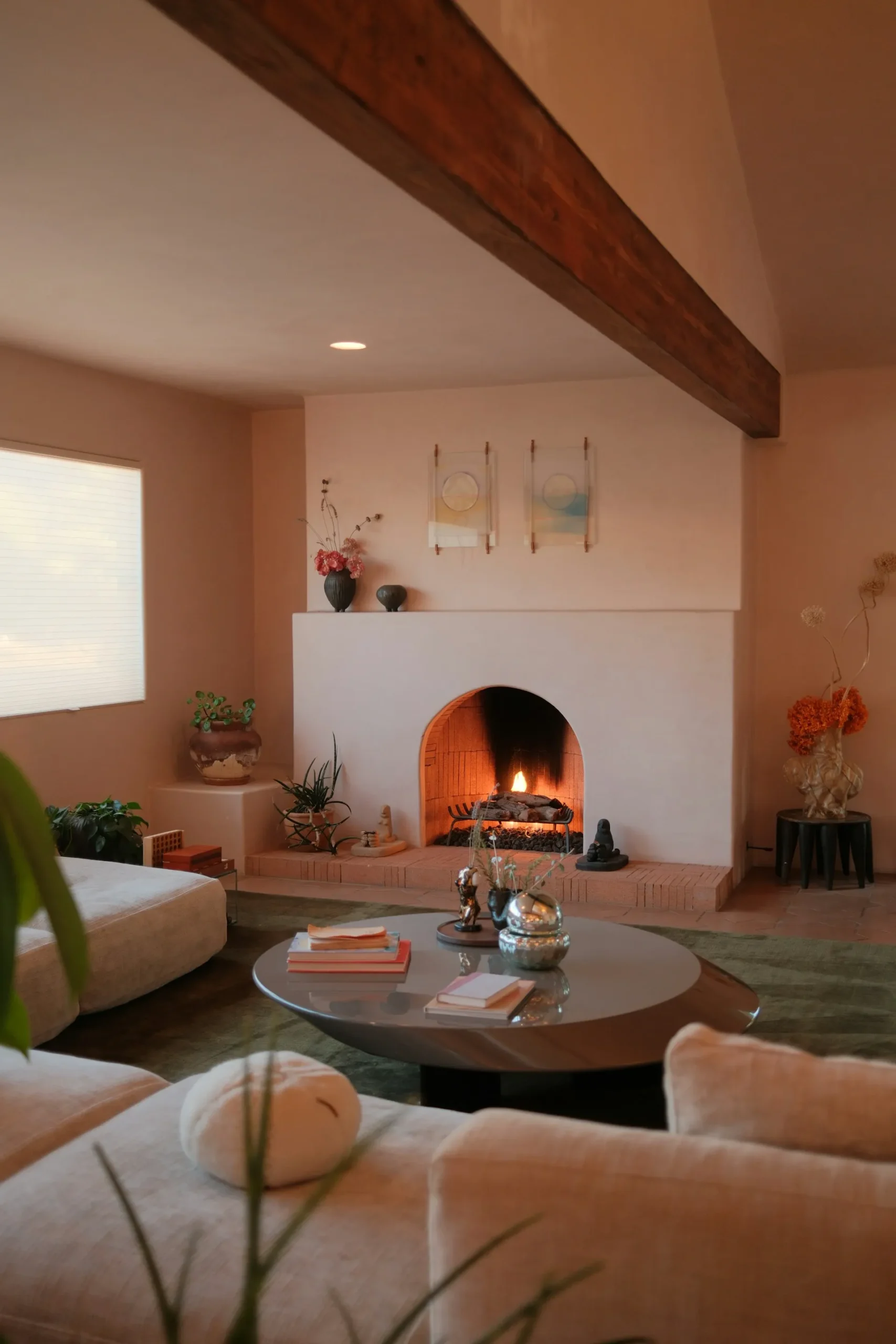 Living area with a lit fireplace and a center coffee table